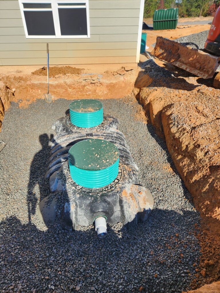 Septic tank with two access risers bedded in gravel, Carolina Septic, CSRA
